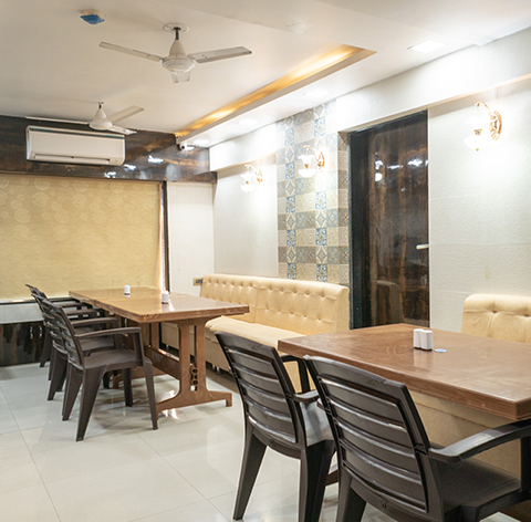 Dining area with wooden tables and banquette seating