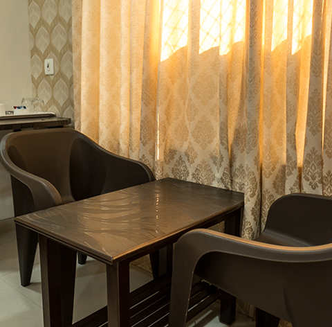 In-room seating with two chairs and a table by the window