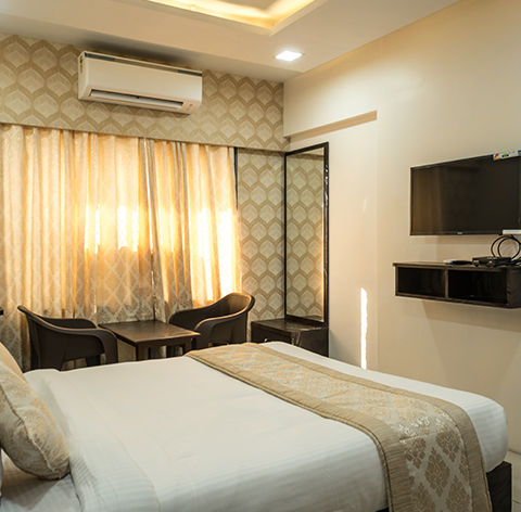 Room with a wall-mounted television and seating
